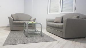 a living room with a couch and a table at Airport view Apartment in Belgrade
