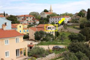 a yellow house in the middle of a city at Apartment Lilly in Nerezine