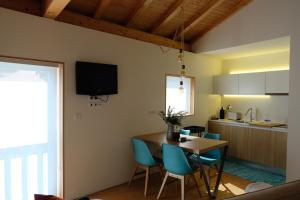 a kitchen and dining room with a table and chairs at Casa Sulfato in Campo do Gerês +10 photos