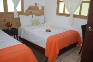 Postel nebo postele na pokoji v ubytování Hotel Rancho Constanza & Cabañas de la Montaña