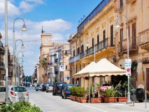 una calle de la ciudad con coches aparcados en la calle en Casa Tresca - Holiday Accommodations, en Menfi