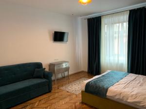 a living room with a couch and a bed at 1790 Margarethengasse Guesthouse in Sibiu