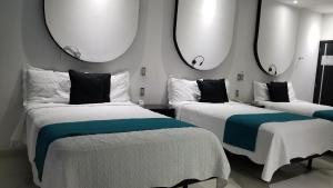 Postel nebo postele na pokoji v ubytování Hotel Dluxe