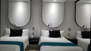 Postel nebo postele na pokoji v ubytování Hotel Dluxe