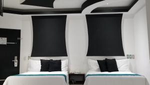 Postel nebo postele na pokoji v ubytování Hotel Dluxe