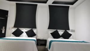 Postel nebo postele na pokoji v ubytování Hotel Dluxe