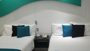 Postel nebo postele na pokoji v ubytování Hotel Dluxe