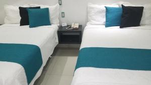 Postel nebo postele na pokoji v ubytování Hotel Dluxe