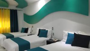 Postel nebo postele na pokoji v ubytování Hotel Dluxe