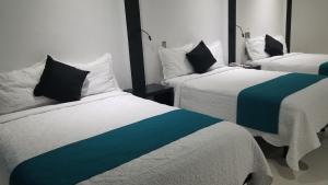 Postel nebo postele na pokoji v ubytování Hotel Dluxe