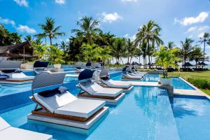 a pool at the resort with lounge chairs at Tivoli Ecoresort Praia do Forte in Praia do Forte