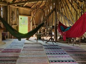 a room with hammocks in a barn with rug at Olo Tila in Kurikka