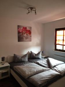 a bedroom with a bed with two pillows on it at Ferienwohnung Hampel in Eisenach