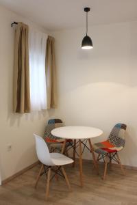 a table and chairs in a room with a window at Apartment Jabucanin in Cetinje