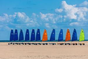 a row of sailboats on a sandy beach at Charmant studio bord de mer in Ouistreham +10 photos