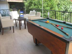 a pool table with balls and cues on a patio at Angels Inn Marmaris in Marmaris