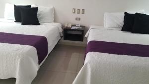 Postel nebo postele na pokoji v ubytování Hotel Dluxe