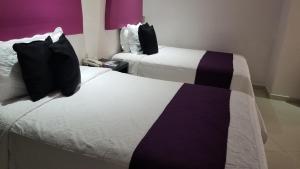 Postel nebo postele na pokoji v ubytování Hotel Dluxe