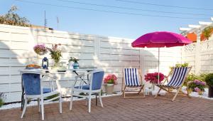 a patio with a table and chairs and an umbrella at Baltiq Spot Rewa in Rewa +50 photos