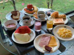 a tray of different types of breakfast foods on a table at Residencial Pantanal Vila Mariana in Sao Paulo +17 photos