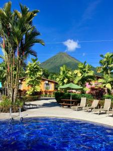 a resort with a pool and a mountain in the background at Hotel Villas Vilma in Fortuna