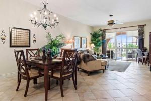 a dining room with a table and chairs and a living room at Ave Maria Rentals Fl in Immokalee