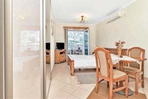 a living room with a table and a bedroom at Apartments Jovanovic in Kotor