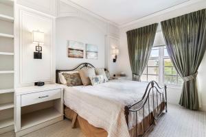 a white bedroom with a bed and a window at Ave Maria Rentals Fl in Immokalee