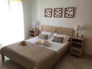 a bedroom with a large bed with two night stands at Villa Christina Anidri in Ánidhroi