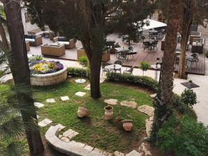 an aerial view of a garden with tables and chairs at Sergei Palace Hotel in Jerusalem