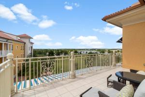 a balcony with a table and chairs with a view at Ave Maria Rentals Fl in Immokalee