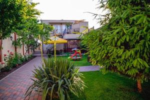a garden with a playground and a house at Casa Andu in 2 Mai