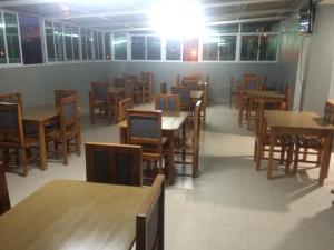 ein Esszimmer mit Tischen und Stühlen und vielen Tischen in der Unterkunft Pensao Motel Sodade in São Filipe