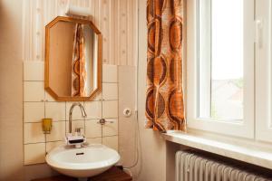 a bathroom with a sink and a mirror and a window at Monteurzimmer Linde in Limbach +37 photos