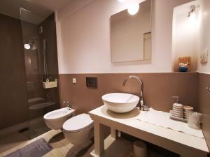 a bathroom with a sink and a toilet and a mirror at ROMANTIC APARTMENT Lovran - 4 stars in Lovran +20 photos