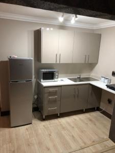 an empty kitchen with a refrigerator and a sink at Annies Place Self Catering in Kempton Park