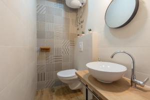 a bathroom with a sink and a toilet and a mirror at Apartment Henna Pula in Pula +22 photos