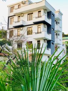 a building with a plant in front of it at Holiday House Green Cape Batumi in Mtsvane Konts'khi