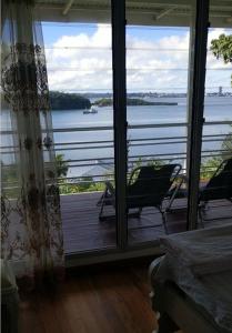 a room with a large window with a view of the water at Suva Hideaway Villa in Suva