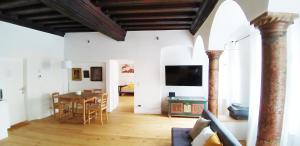 a living room with a table and a dining room at Renaissance Apartment Marktplatz in Gmunden