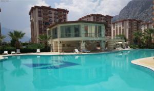 a large swimming pool in front of a building at Antalya Guest Home in Antalya