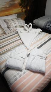two white towels are sitting on a bed at Moonlight in Vidigueira