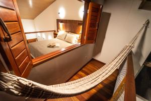 a hammock in a room with a bedroom at Vila Loop in São Miguel do Gostoso