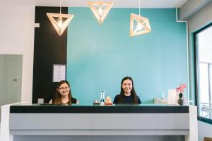 two women sitting at a counter in a dental office at Napsule Suites in Davao City