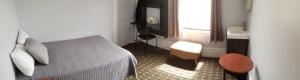a small bedroom with a bed and a window at Perramont Hotel in San Francisco