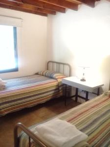 Ένα ή περισσότερα κρεβάτια σε δωμάτιο στο Cabañas San Miguel