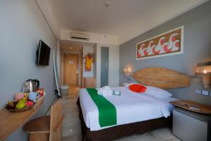 a hotel room with a bed and a bowl of fruit at Koa D Surfer Hotel in Canggu