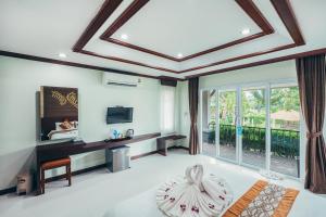 a living room with a coffered ceiling at Palm Kiri Aonang Resort in Ao Nang Beach