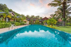 a swimming pool in front of a villa at Palm Kiri Aonang Resort in Ao Nang Beach