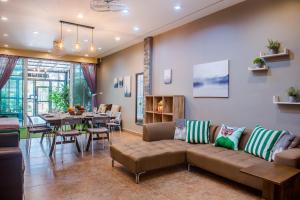 a living room with a couch and a dining room at Super nice townhouse in city center, 10 minutes walk to beach, night market ... in Hua Hin